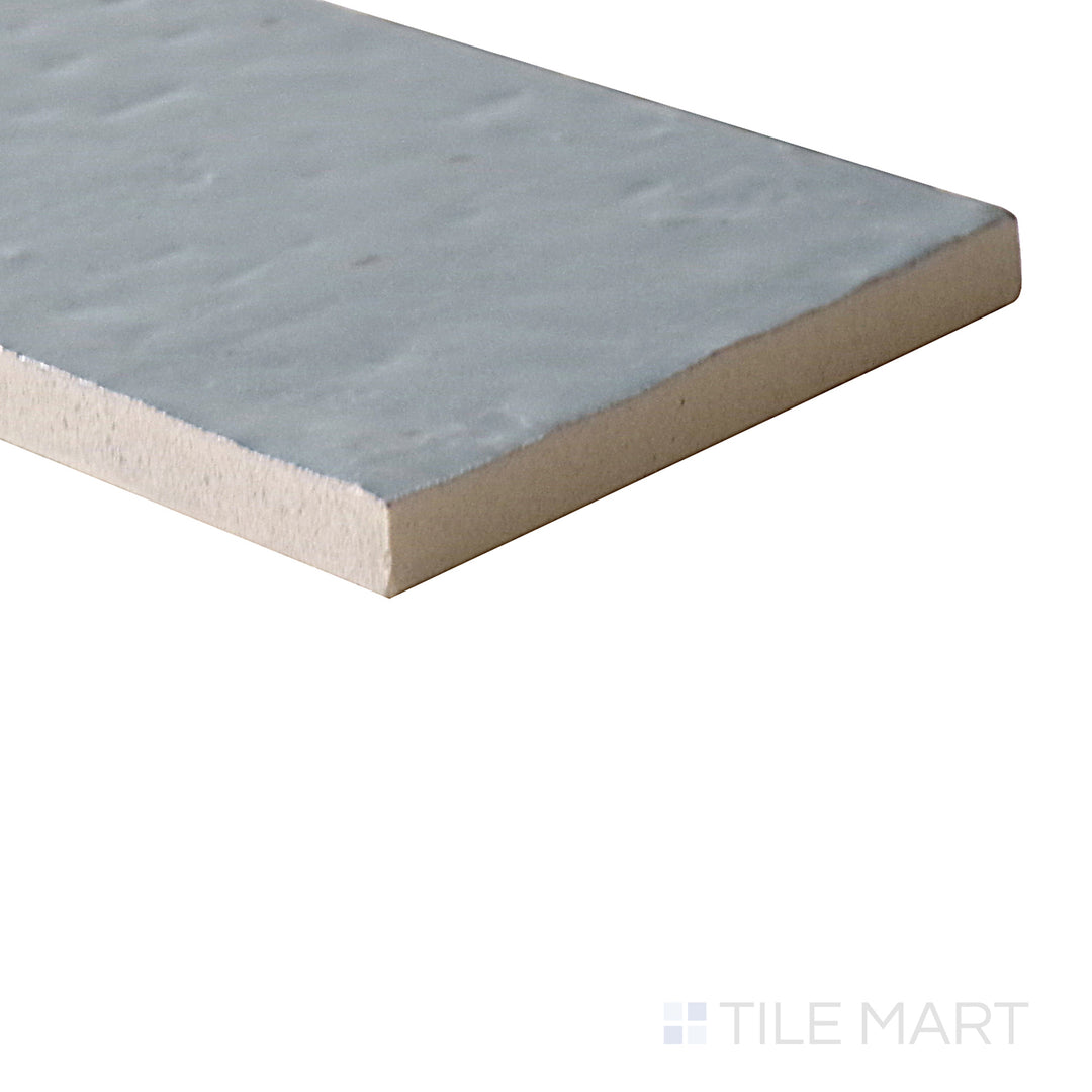 Diagonal view of Glace Avio 3x8 glossy porcelain tile, showcasing its striking blue shade, reflective glossy sheen, and structured rectangular design.  