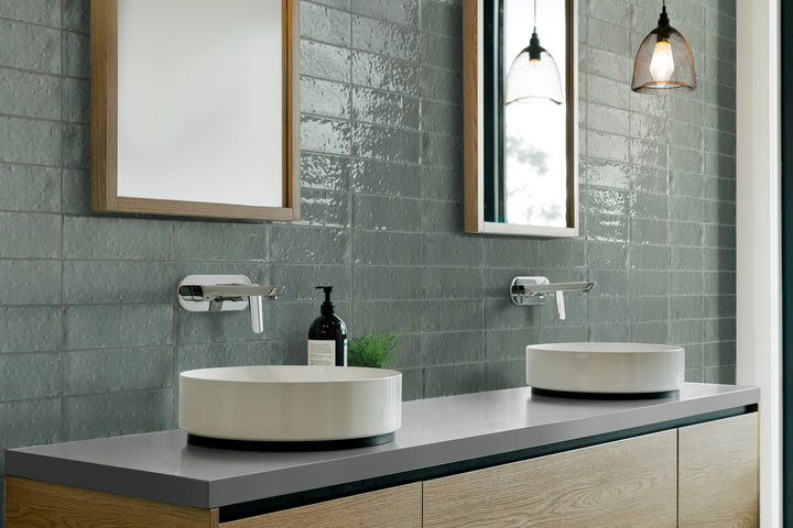 A chic and modern ambiance with Glace Avio 3X8 Glossy Porcelain, reflecting a soft, serene blue hue with a high-gloss finish.