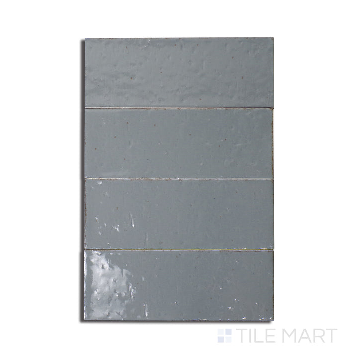 Top-down shot of Glace Avio 3X8 Glossy Porcelain, a sleek glossy tile in a muted blue shade, offering a refined and elegant finish.