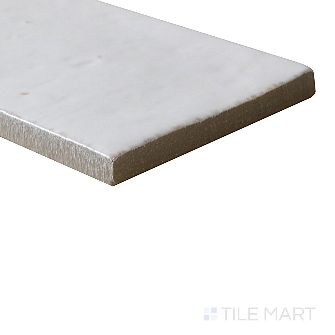 Slanted perspective of Glace Bianco 3x8 glossy porcelain tile, emphasizing its bright white color, high-gloss finish, and modern rectangular format.  