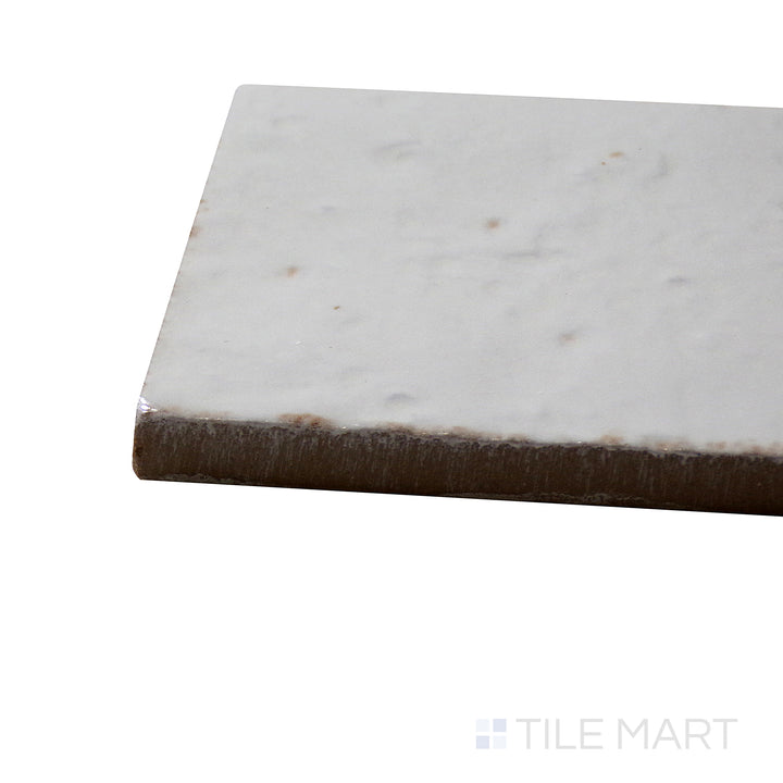 Angled view of Glace Bianco 3X8 Glossy Porcelain Tile, highlighting its crisp white shade with a sleek, reflective finish.