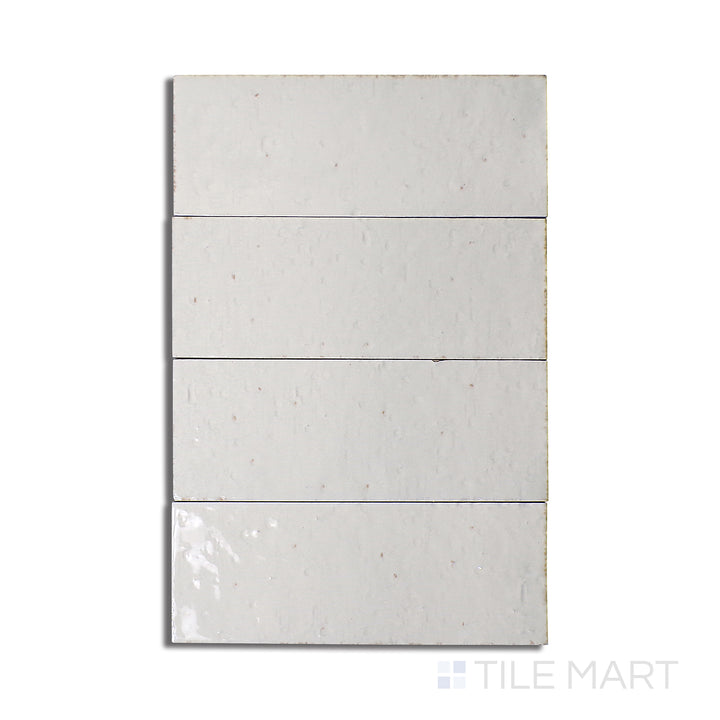 Flat-lay of Glace Bianco 3X8 Glossy Porcelain, a pristine white tile with a high-gloss surface, reflecting light beautifully for a bright interior.