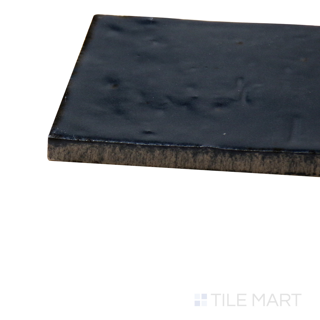 Close-up corner shot of Glace Blu Notte 3X8 Glossy Porcelain Tile, featuring its deep navy blue tones with a radiant, polished surface.