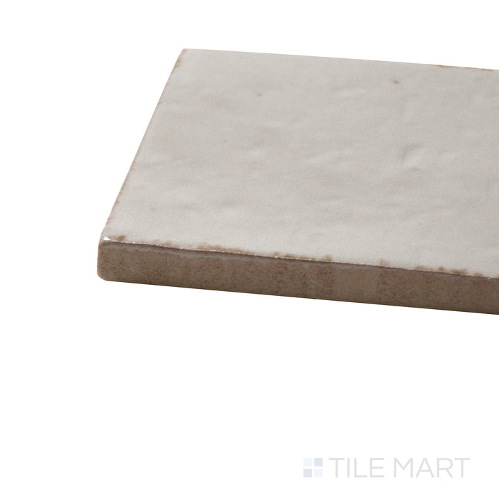 Corner angle of Glace Mastice 3X8 Glossy Porcelain Tile, emphasizing its warm neutral hues with a glossy, smooth texture.