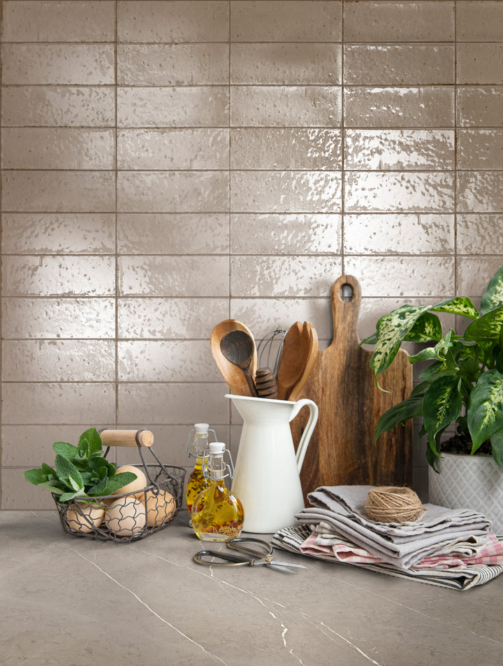 A refined and neutral aesthetic enhanced by Glace Mastice 3X8 Glossy Porcelain, offering soft taupe tones in a sleek, polished design.