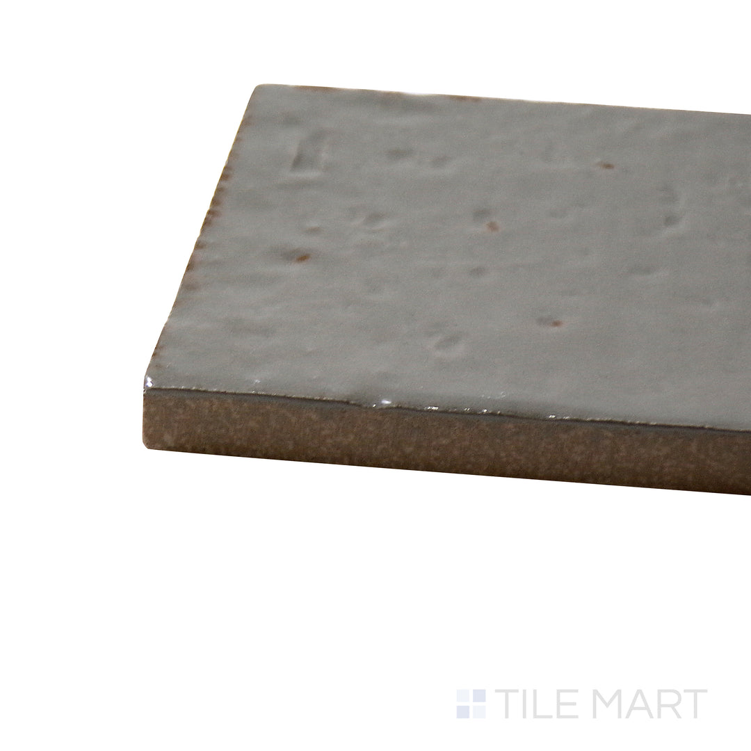 Side perspective of Glace Muschio 3X8 Glossy Porcelain Tile, capturing its soft moss green tones with a sleek, high-shine finish.