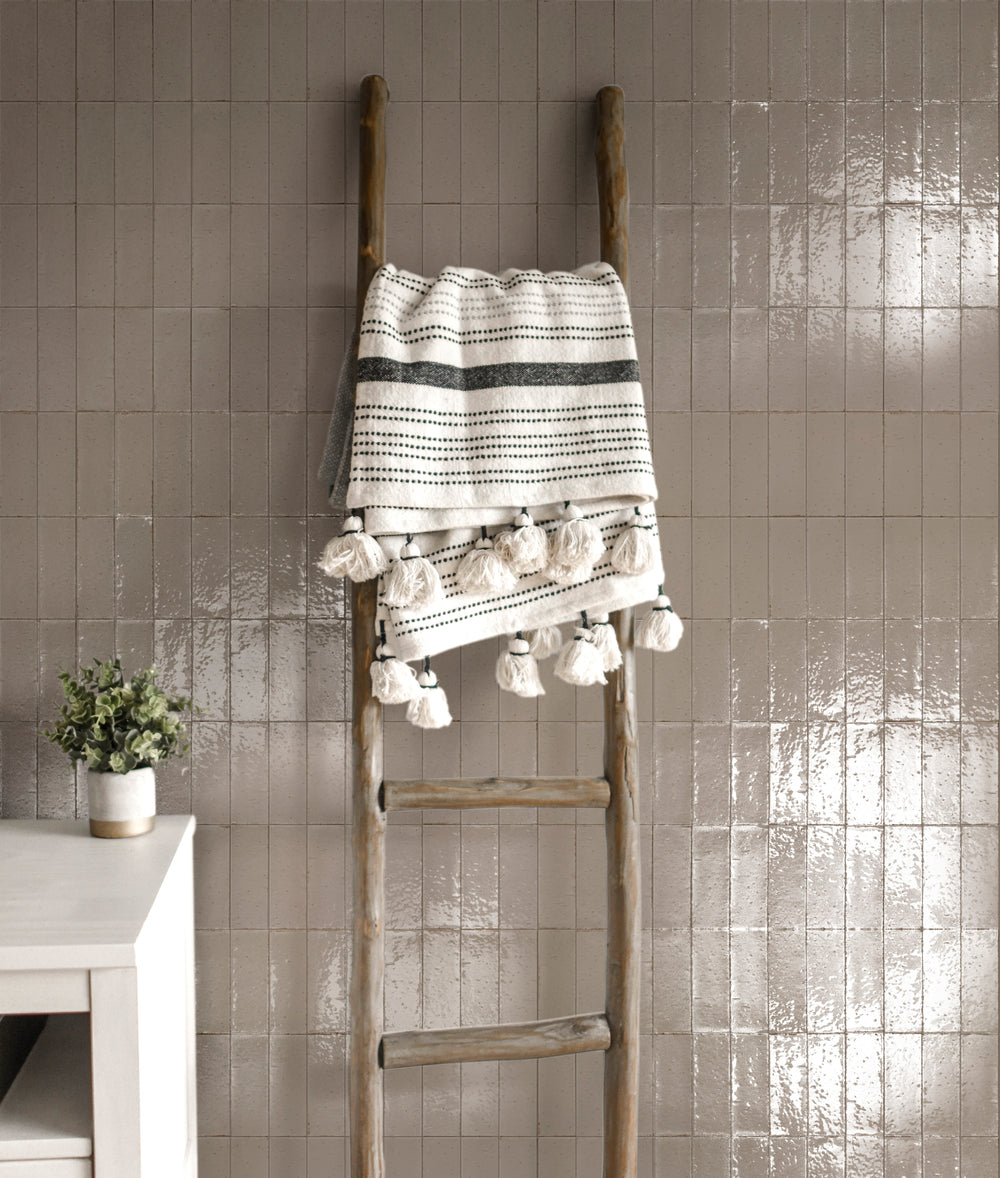 A nature-inspired interior featuring Glace Muschio 3X8 Glossy Porcelain, with rich green hues that create a refreshing, elegant look.