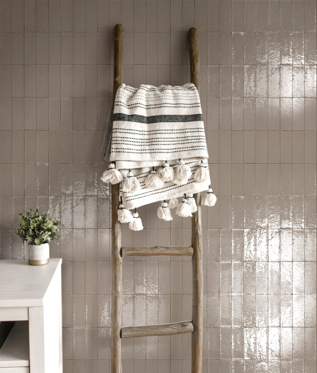 A nature-inspired interior featuring Glace Muschio 3X8 Glossy Porcelain, with rich green hues that create a refreshing, elegant look.