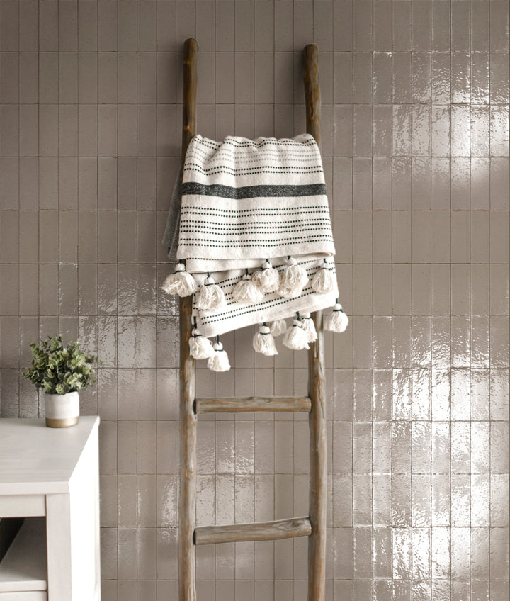 A nature-inspired interior featuring Glace Muschio 3X8 Glossy Porcelain, with rich green hues that create a refreshing, elegant look.