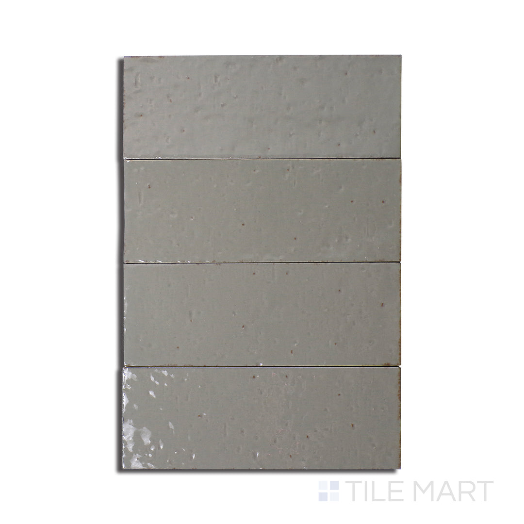 Flat-lay of Glace Muschio 3X8 Glossy Porcelain, a muted green tile with a high-shine glossy surface, creating a modern and organic look.