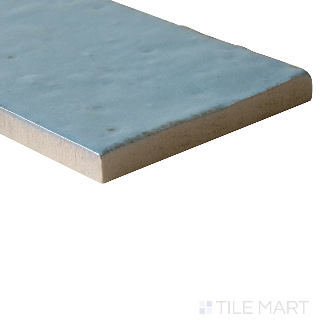 Angled shot of Glace Turchese 3x8 glossy porcelain tile, featuring a vibrant turquoise color, high-gloss reflective surface, and contemporary rectangular format.  