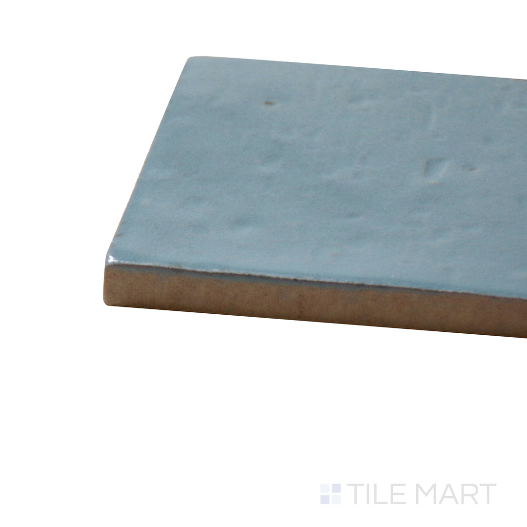 Angled close-up of Glace Turchese 3X8 Glossy Porcelain Tile, showcasing its vibrant turquoise blue color with a polished, glossy surface.