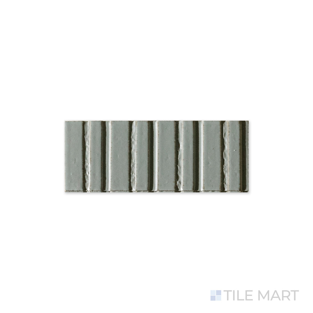 A close-up of Glace Avio 3x8 glossy porcelain tile captures its smooth, reflective surface and rich blue tone, creating a sleek and modern aesthetic.