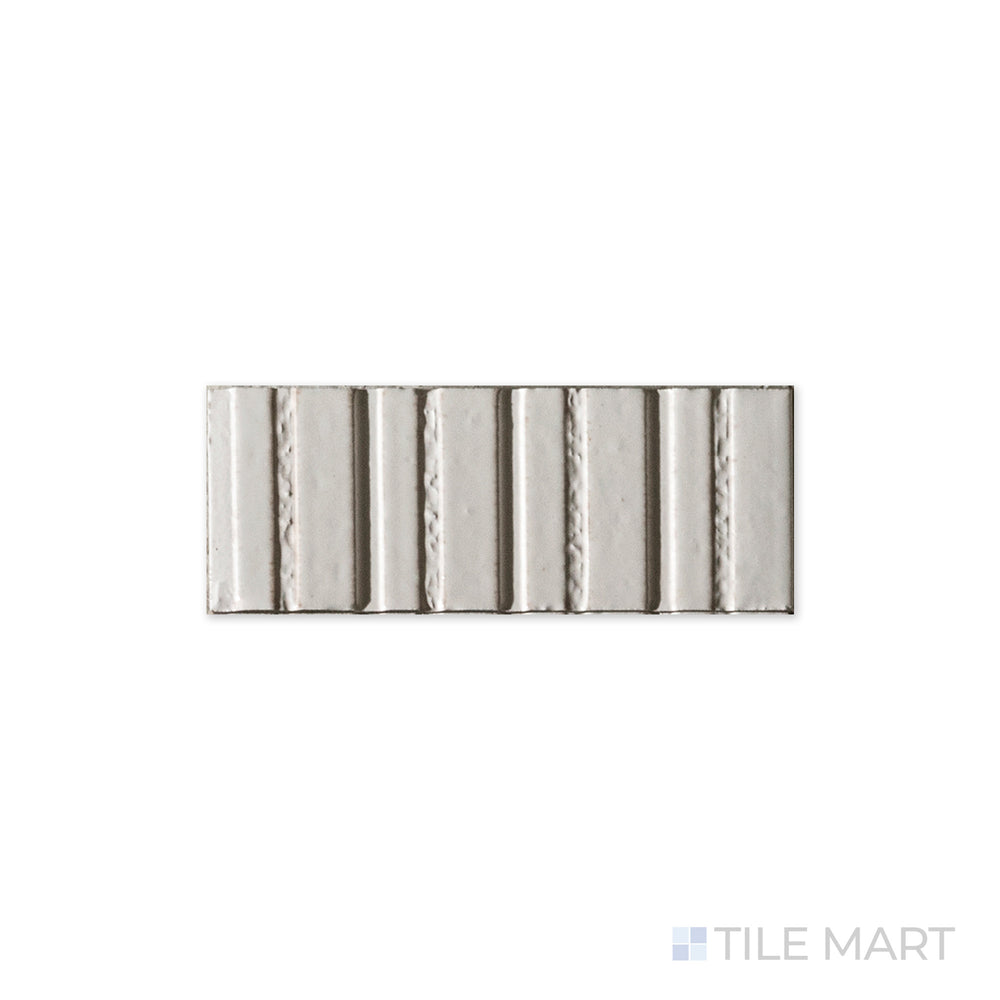 A polished white surface gleams in this detailed close-up of Glace Bianco 3x8 glossy porcelain tile, highlighting its crisp brightness and high-shine finish.