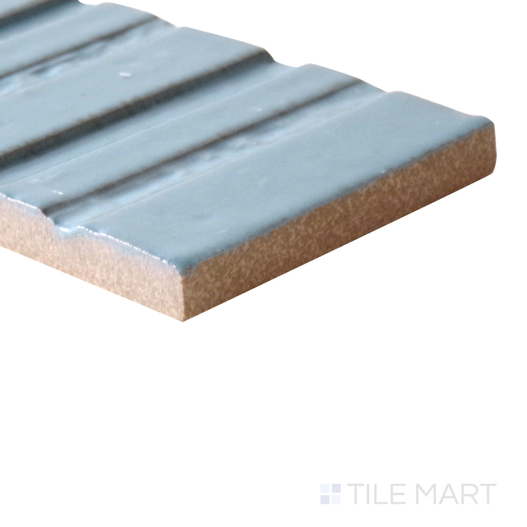 Angled shot of Glace Turchese 3x8 glossy porcelain tile, featuring a vibrant turquoise shade, sleek glossy texture, and an elongated rectangular shape.  