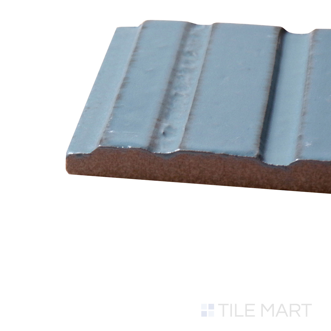 Side perspective of Glace Turchese 3X8 Glossy Porcelain Tile, capturing its bright aqua blue tones with a highly reflective finish.