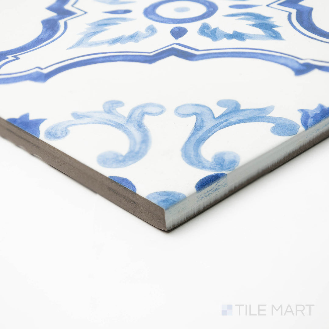 Angled view of Mestral Cross 9x9 matte porcelain tile, presenting its geometric styling, matte surface, and the sharp, well-crafted corner where edges meet.