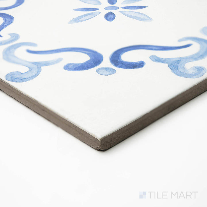 Angled shot of Mestral Flower 9x9 matte porcelain tile, focusing on its artistic floral motif and the precise, beveled edges that form a seamless corner.
