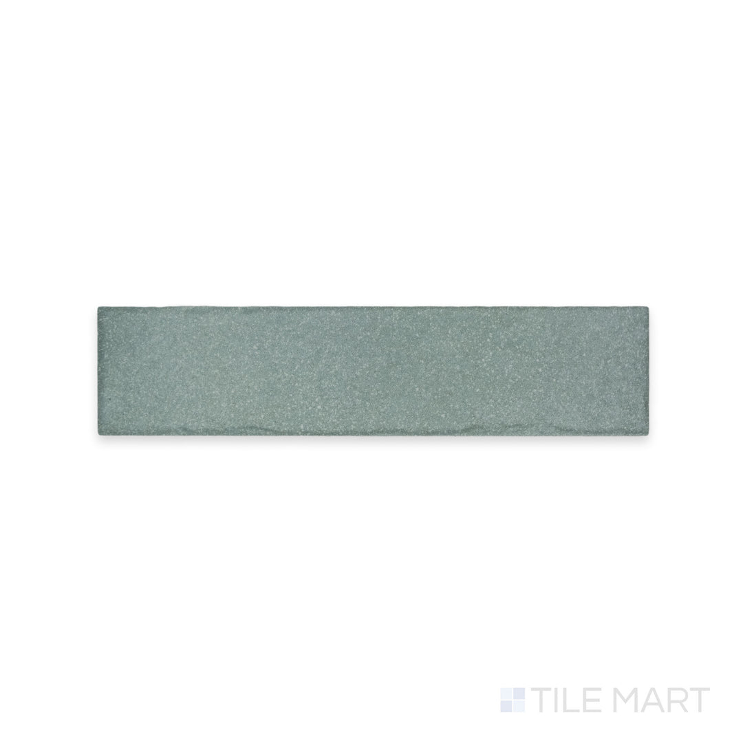 A muted, earthy tone with a smooth matte texture is captured in this macro shot of Tetris Aria 2x8 matte porcelain tile, perfect for subtle elegance.