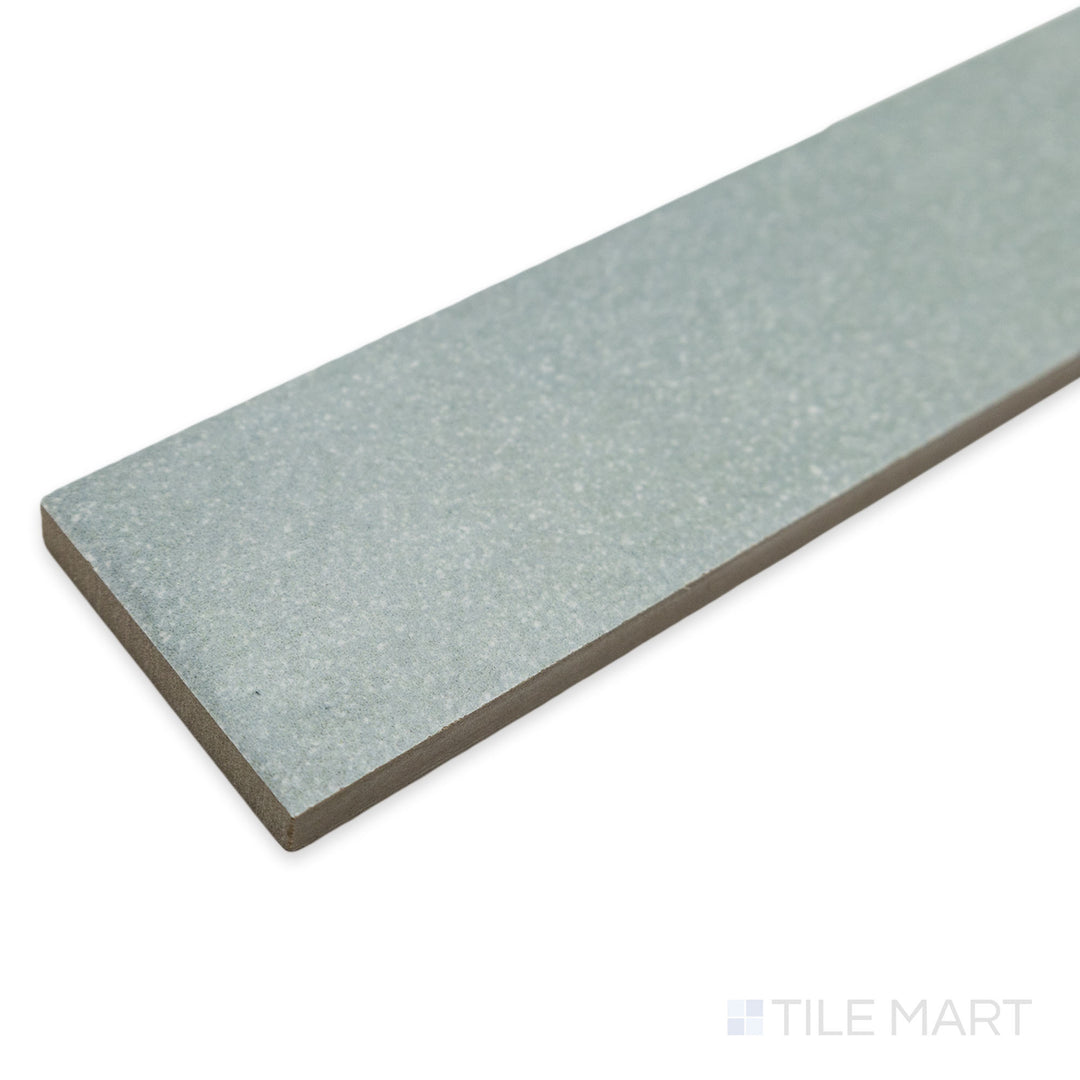 Angled corner view of Tetris Aria 2x8 matte porcelain tile, highlighting its soft neutral hue, precise cut, and the way light interacts with its smooth surface.