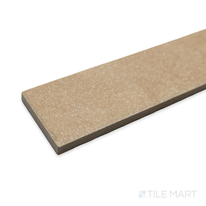 Side-angle perspective of Tetris Ecru 2x8 matte porcelain tile, featuring an earthy beige shade with finely crafted edges that form a sleek, seamless transition.