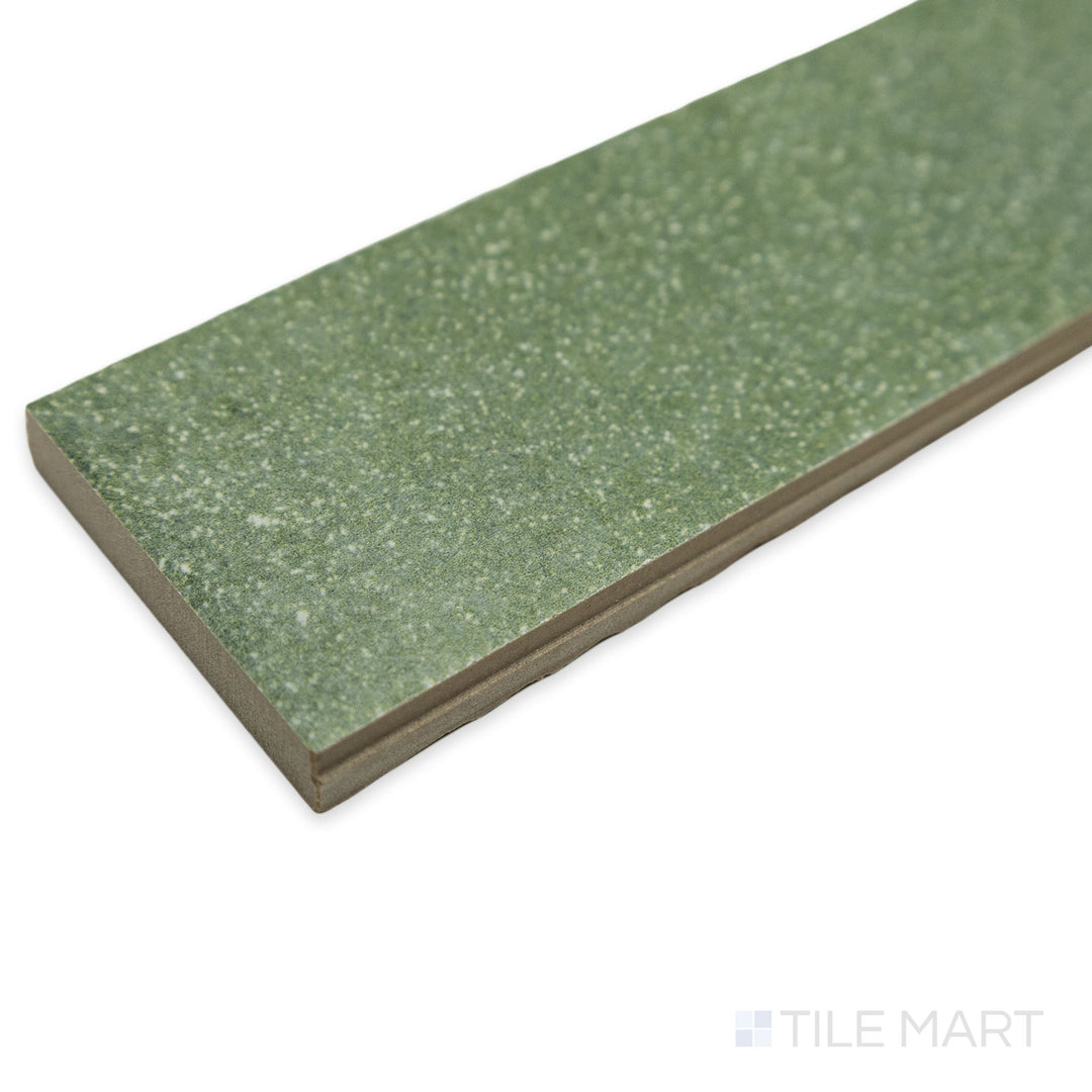 Close-up corner shot of Tetris Muschio 2x8 matte porcelain tile, drawing attention to its muted green tone, structured format, and the crisp meeting of its edges.