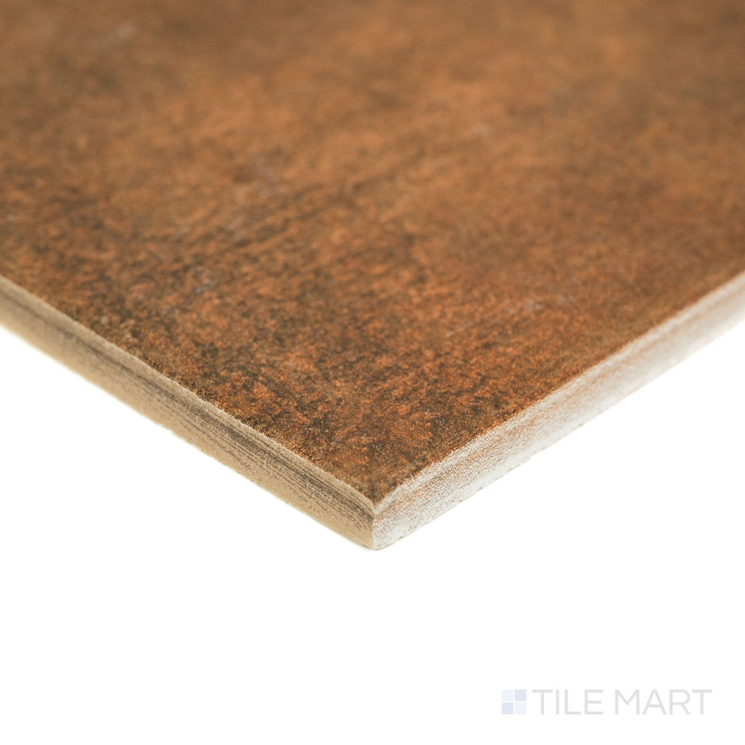 Corner angle of Valdorcia Cotto Versailles Pattern matte porcelain tile, highlighting its earthy red tone, textured surface, and the layered edge profile visible from the side.