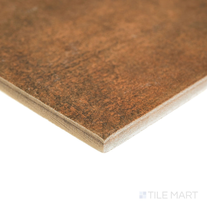 Corner angle of Valdorcia Cotto Versailles Pattern matte porcelain tile, highlighting its earthy red tone, textured surface, and the layered edge profile visible from the side.