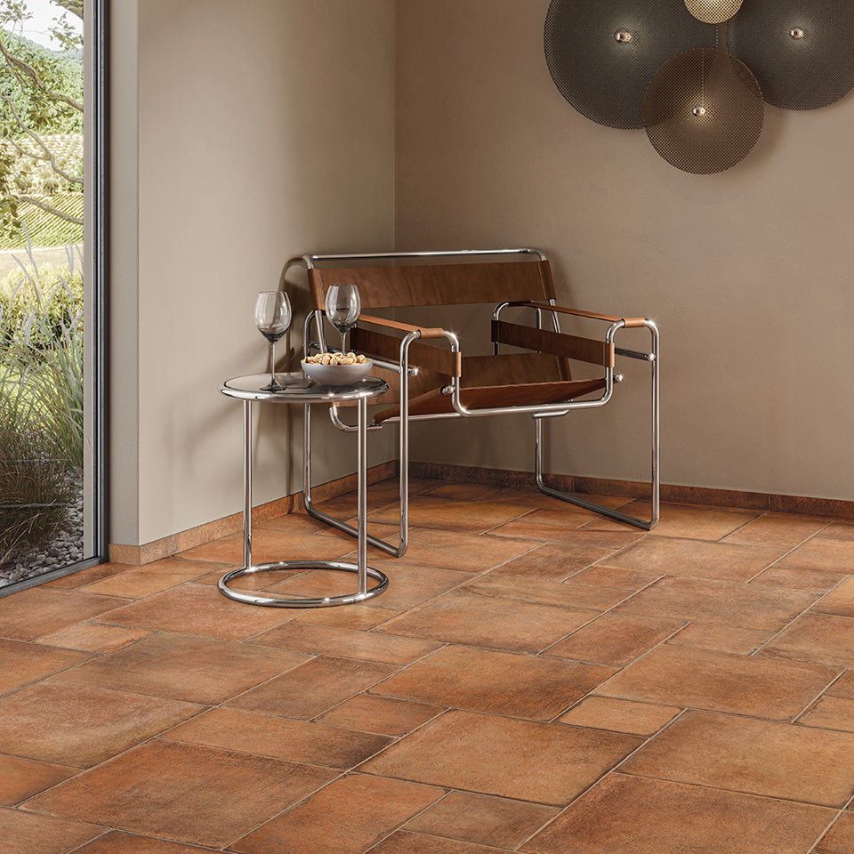 A warm and rustic ambiance is created with earthy hues, perfectly complementing the Valdorcia Cotto Versailles Pattern Matte Porcelain.
