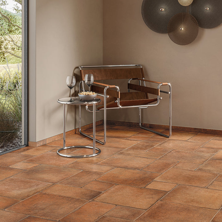 A warm and rustic ambiance is created with earthy hues, perfectly complementing the Valdorcia Cotto Versailles Pattern Matte Porcelain.