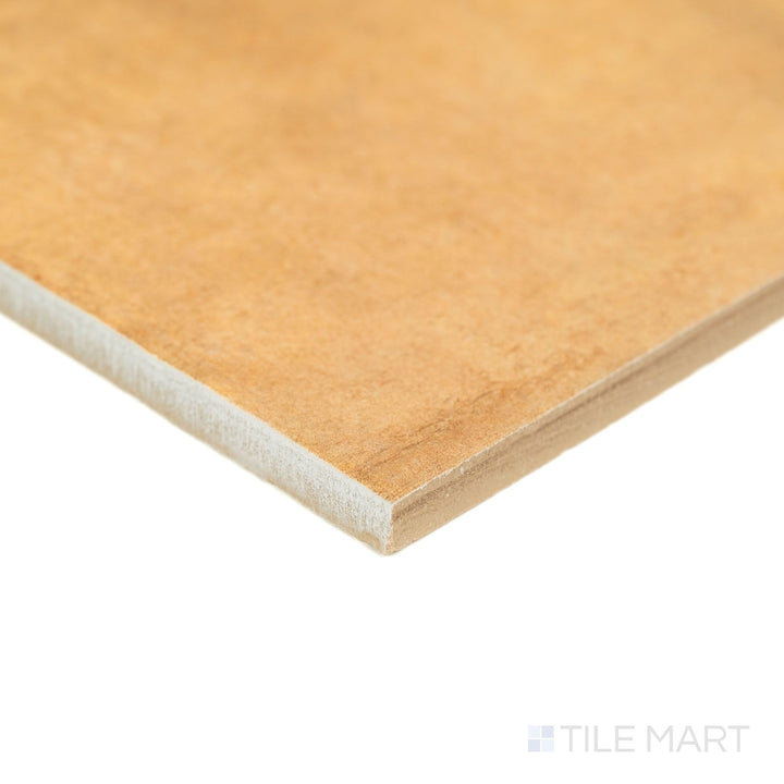 Captured at a corner perspective, the Valdorcia Ocra Versailles Pattern matte porcelain tile displays its golden ochre color variation and rustic matte finish along with defined edge lines.