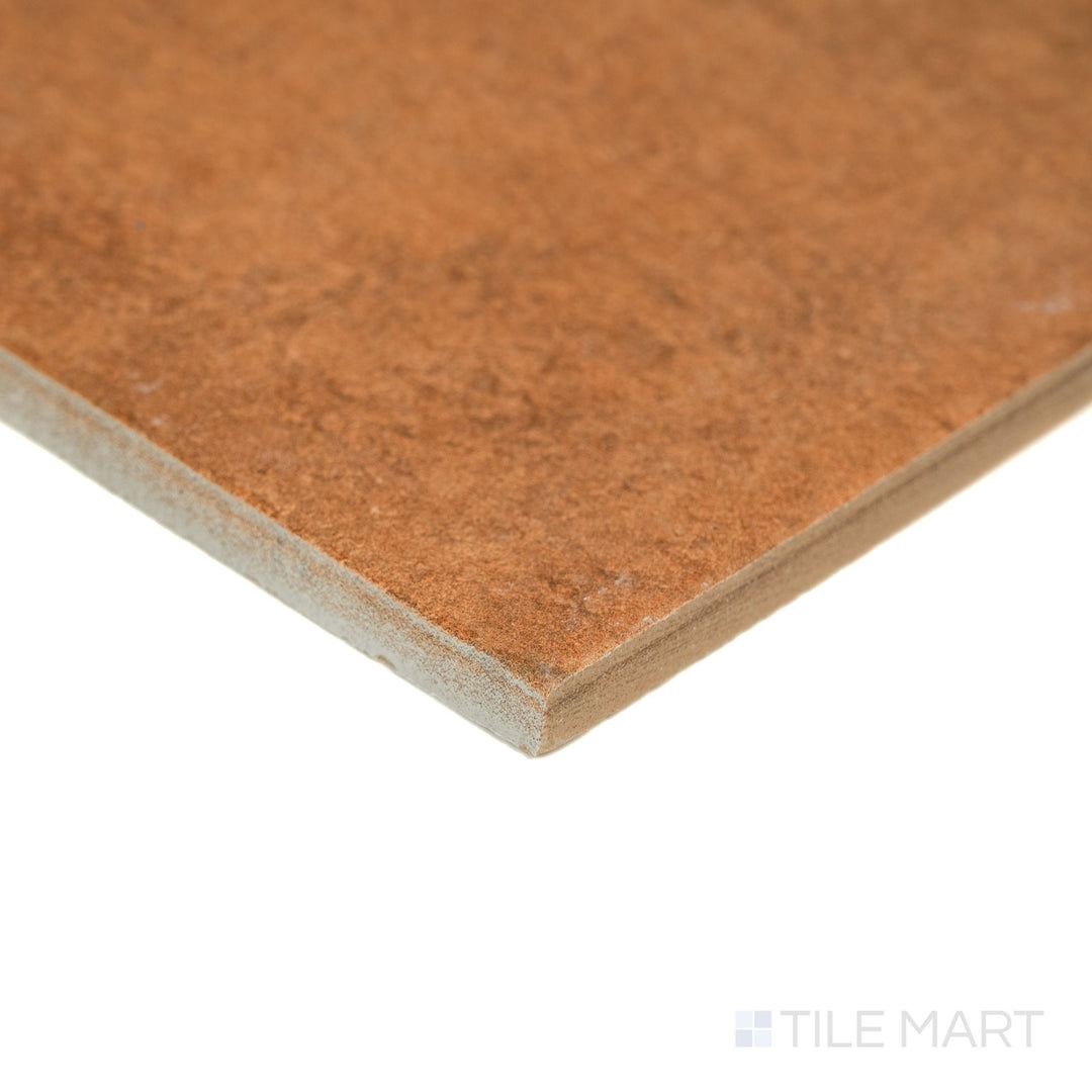 Valdorcia Terracotta Versailles Pattern matte porcelain tile shown from an angled corner view, revealing warm terracotta hues, subtle texture, and the multi-size layout cut visible at the edges.