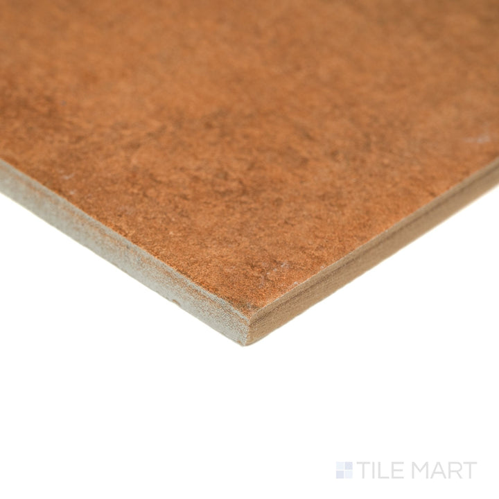 Valdorcia Terracotta Versailles Pattern matte porcelain tile shown from an angled corner view, revealing warm terracotta hues, subtle texture, and the multi-size layout cut visible at the edges.