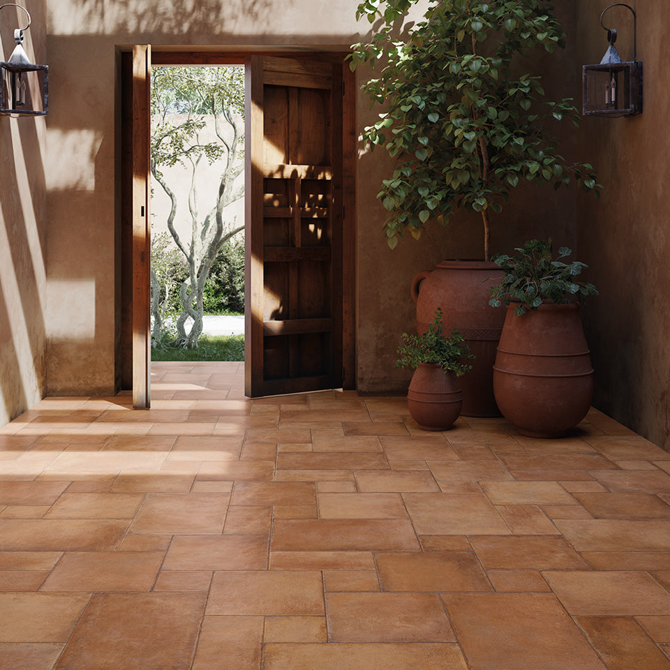 An authentic and timeless appeal defines the space, accentuated by Valdorcia Terracotta Versailles Pattern Matte Porcelain.