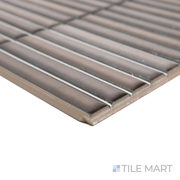 Corner-focused shot of Karatsu Charcoal 4.5x9 matte porcelain tile, emphasizing its bold, dark finish, structured cut, and seamless edge connection.