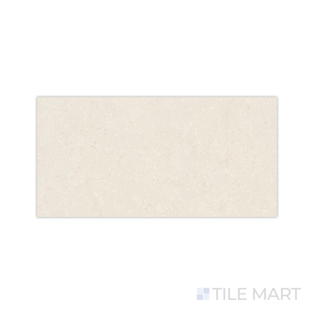A smooth matte texture with warm coral undertones is detailed in this close-up of Pietra Coral Natural 24x48 matte porcelain tile, offering a soft and inviting appeal.