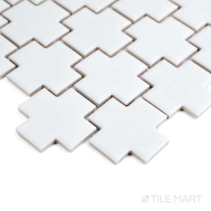 This corner shot captures the White Cross mosaic’s crisp geometry and soft matte finish on glazed porcelain.
