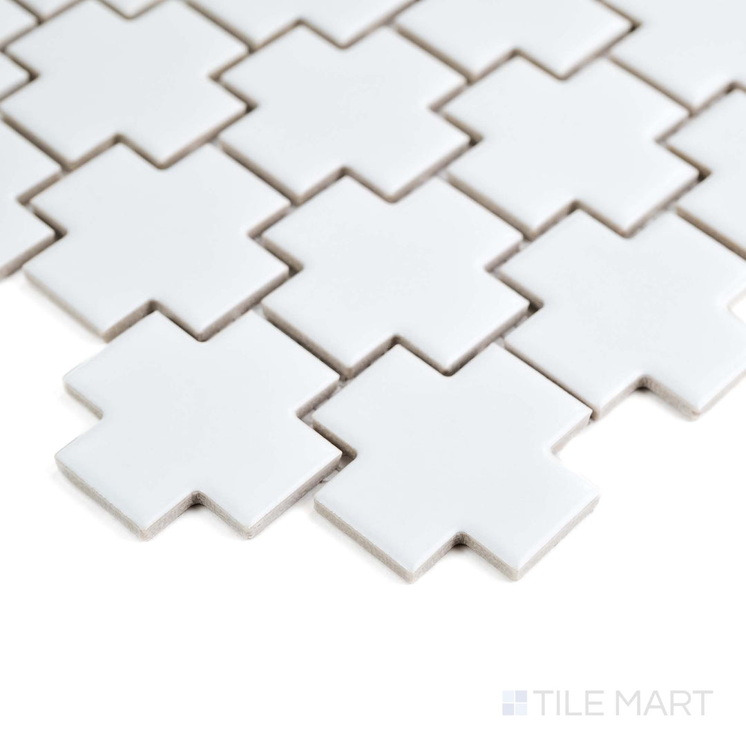 This corner shot captures the White Cross mosaic’s crisp geometry and soft matte finish on glazed porcelain.
