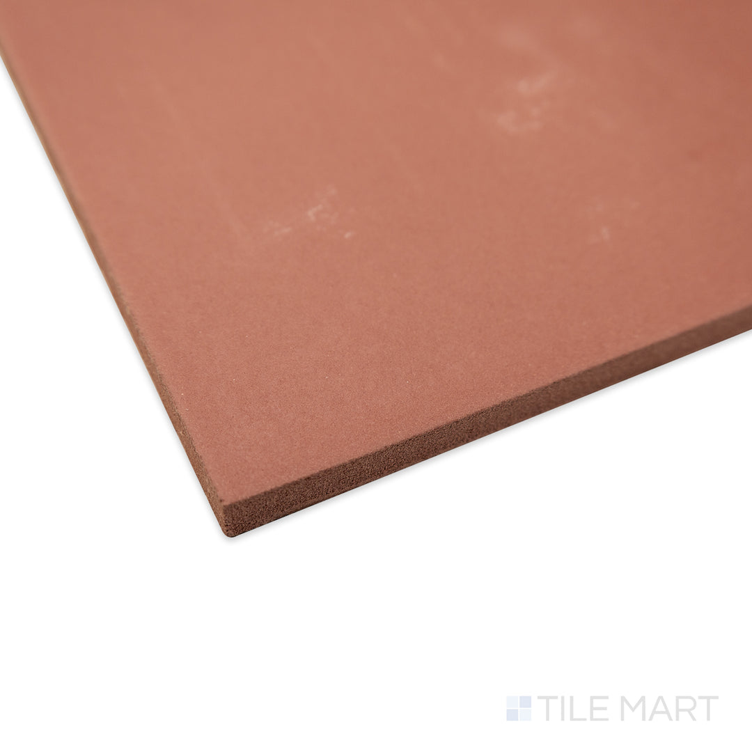 Close-up of Quarry + Red 6x6 matte ceramic tile at a corner angle, showcasing its rich, warm tone, structured edges, and soft matte surface.