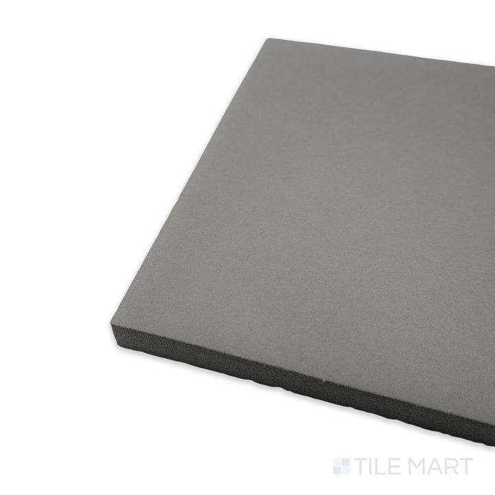 Angled perspective of Quarry + Gray 6x6 matte ceramic tile, featuring its cool-toned hue, finely crafted edges, and how its surface transitions smoothly at the corner.