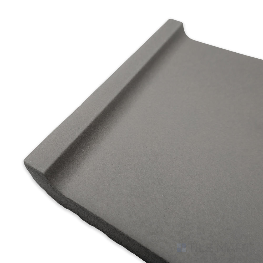 Corner perspective of Quarry + Gray 6x6 matte ceramic cove base, highlighting its soft grey tone with a rounded edge and refined matte texture.