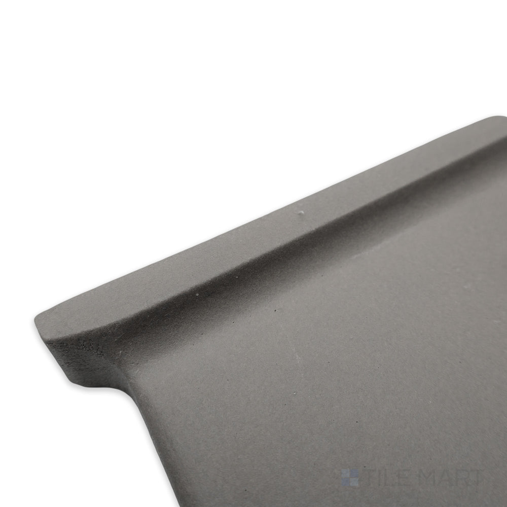 Corner perspective of Quarry + Gray 6x6 matte ceramic outside corner left, highlighting its soft grey tone with a structured corner shape and matte texture.