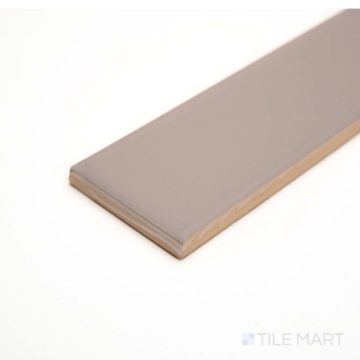 Redend Point tile seen from the edge, showing a muted rose hue with a matte ceramic texture.