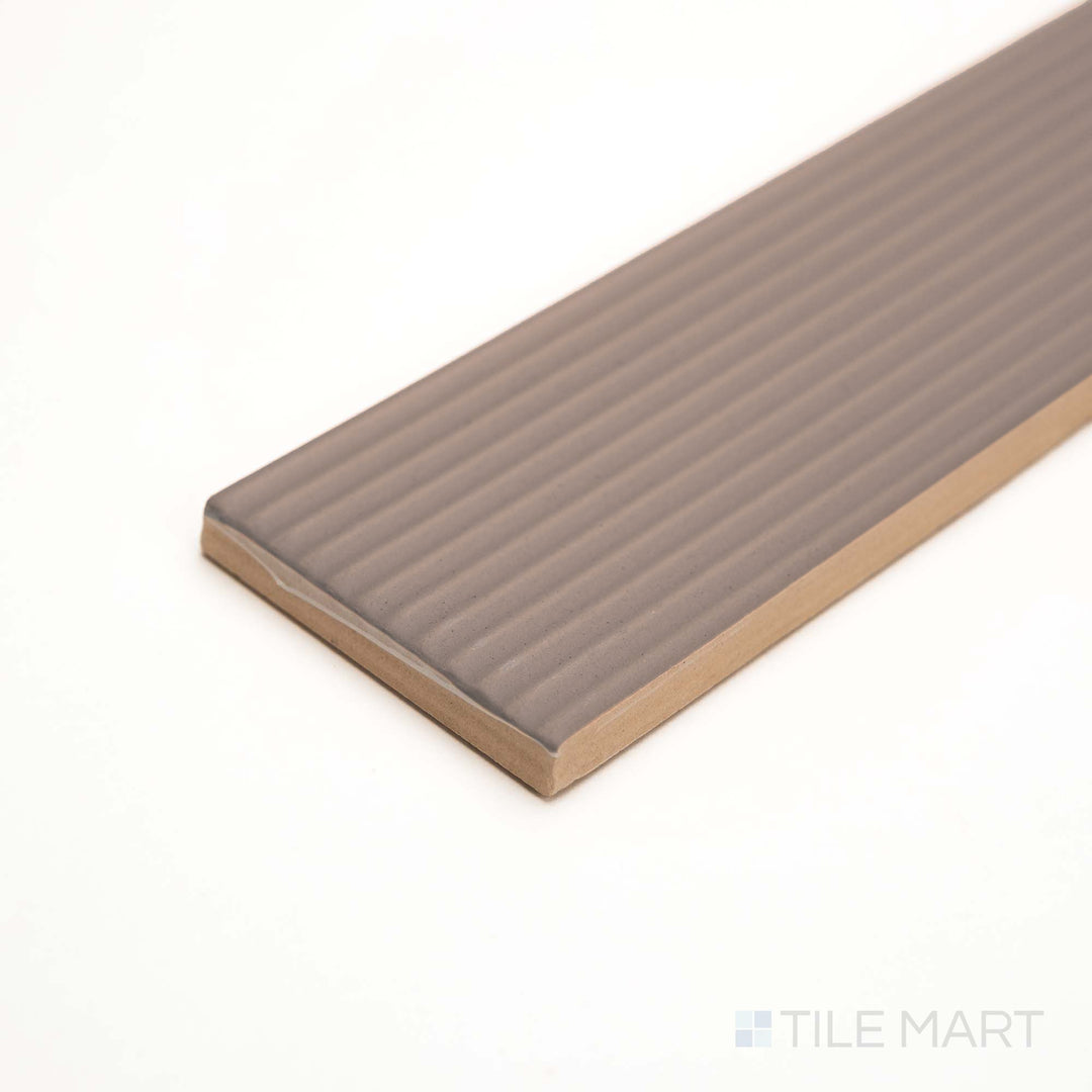 This close side view captures Redend Point’s striped ceramic pattern with warm, muted rose tones.