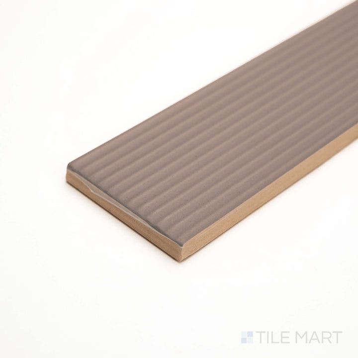 This close side view captures Redend Point’s striped ceramic pattern with warm, muted rose tones.