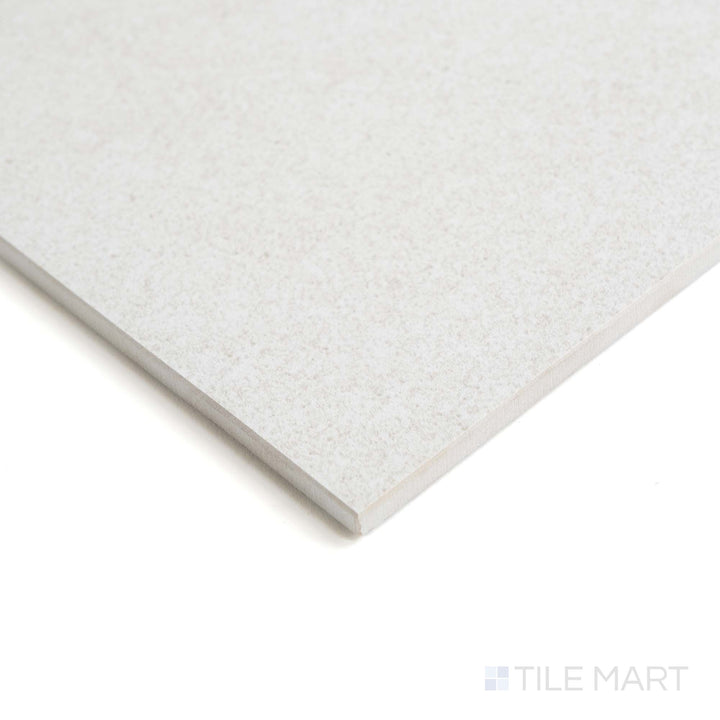 From the edge, Origin Arctic tile displays its cool matte finish and icy white tone with subtle stone patterning.