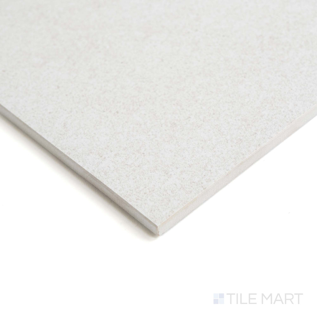 From the edge, Origin Arctic tile displays its cool matte finish and icy white tone with subtle stone patterning.
