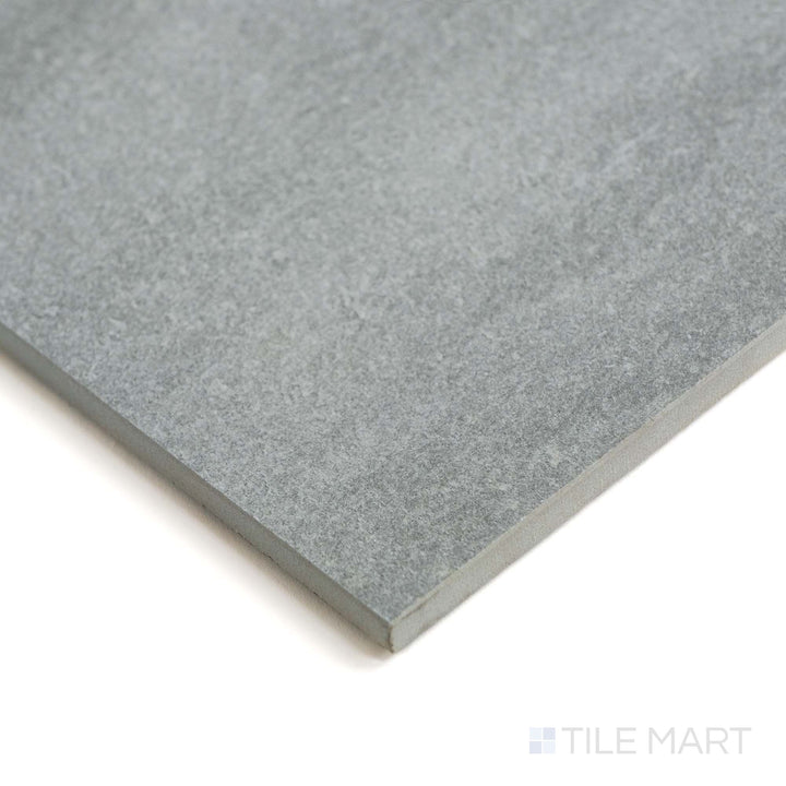 Corner shot of Origin Canyon tile reveals deep earthy tones and a stone-like matte surface.