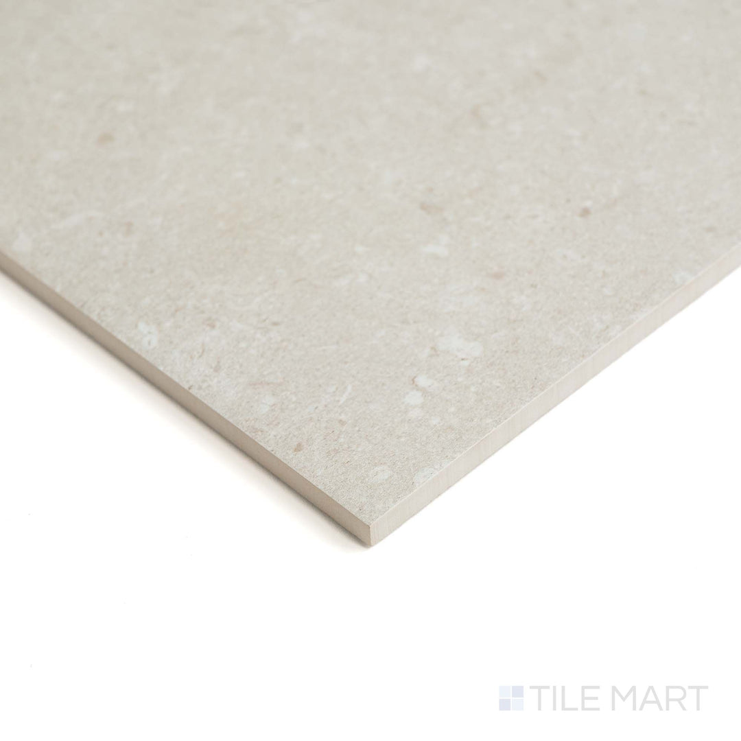 Pietra Coral Sand 48X48 tile appears in a wide corner shot, showing soft sand-like texture and natural matte finish.