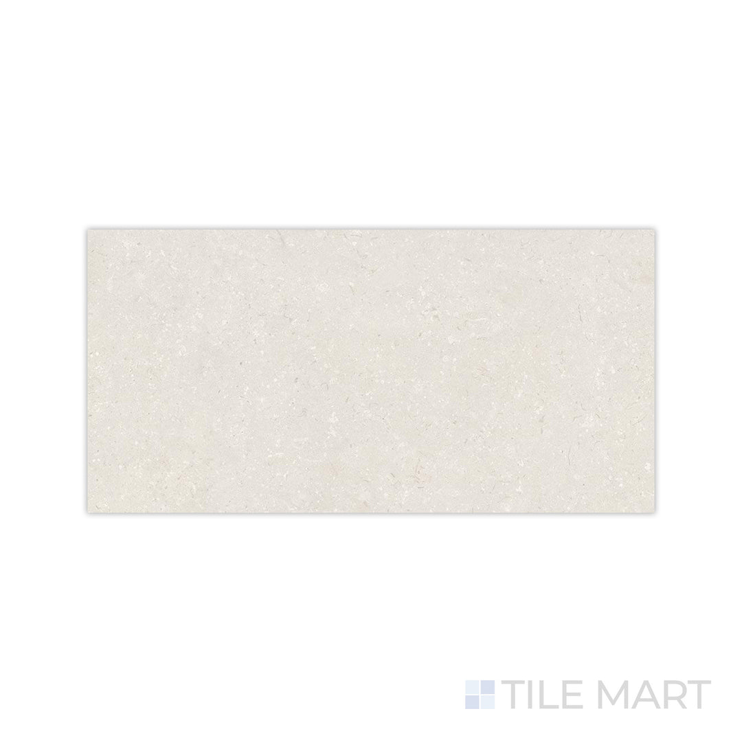 A detailed close-up of Pietra Coral Sand 24x48 matte porcelain tile highlights its fine-grain surface and natural earthy tone, perfect for creating a warm and inviting space.
